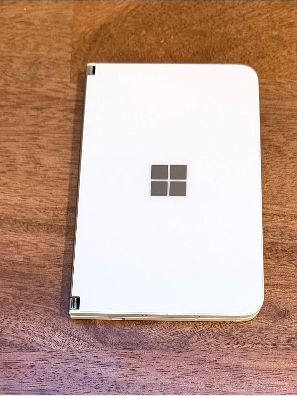 Microsoft White Dual-Screen Foldable Device with Silver Logo